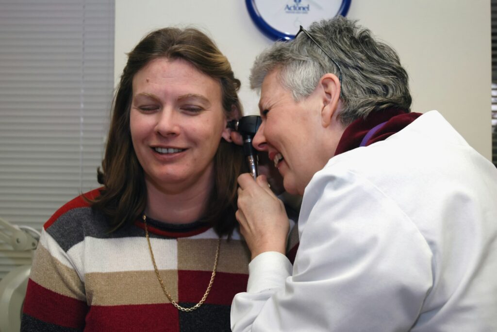 Doctor examining a patient's ear during a check-up