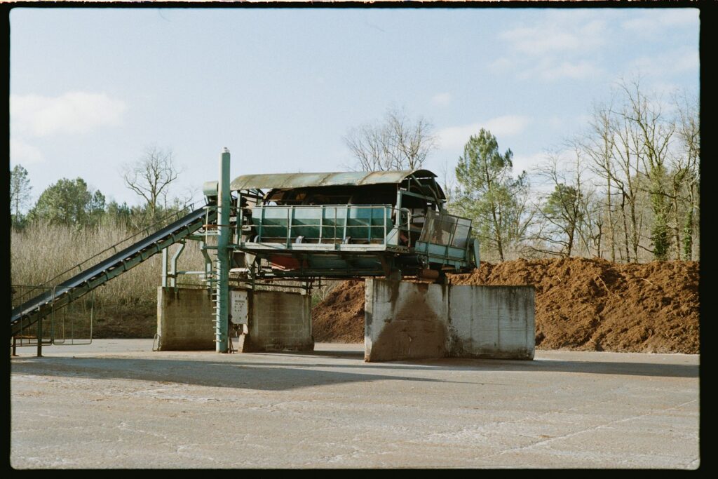 Industrial machinery with conveyor belts and piles of material, where wear points take heavy abrasion
